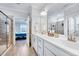 Bathroom featuring double sinks, a large mirror and a shower enclosure, providing a luxurious feel at 244 Mahogany Run, Raleigh, NC 27610