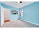 Light blue bedroom featuring a closet and a mounted television at 244 Mahogany Run, Raleigh, NC 27610
