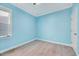 Empty light blue bedroom featuring carpeted floor, window and closet at 244 Mahogany Run, Raleigh, NC 27610