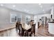 Open concept dining area featuring a wooden table and chairs with views into the kitchen at 244 Mahogany Run, Raleigh, NC 27610