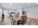 Spacious dining area with hardwood floors and a seamless transition into the kitchen at 244 Mahogany Run, Raleigh, NC 27610