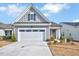 Beautiful single-story home featuring a two-car garage, gray siding, and manicured landscaping at 244 Mahogany Run, Raleigh, NC 27610
