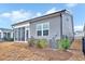 Exterior view of a gray home showcasing a screened in porch and well-maintained landscaping at 244 Mahogany Run, Raleigh, NC 27610