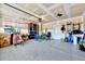 Spacious garage with epoxy flooring, storage, and ceiling fans, providing a functional space at 244 Mahogany Run, Raleigh, NC 27610
