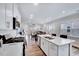 Spacious kitchen featuring white cabinetry, a central island with seating, and an open view to the living area at 244 Mahogany Run, Raleigh, NC 27610