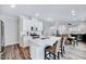 Modern kitchen with white cabinets, quartz countertops, stainless steel appliances, and a large island at 244 Mahogany Run, Raleigh, NC 27610