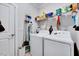 Laundry room equipped with a washer, dryer, and shelving, offering ample storage space at 244 Mahogany Run, Raleigh, NC 27610