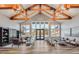 Inviting lobby with vaulted ceilings, wood beams, decorative lighting, modern furnishings, and expansive windows at 244 Mahogany Run, Raleigh, NC 27610