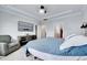 Well-lit main bedroom with a comfortable armchair and entertainment area at 244 Mahogany Run, Raleigh, NC 27610