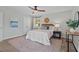 Bright main bedroom with natural light, ceiling fan, carpeted floors, and neutral tones at 2611 Newport Dr, Durham, NC 27705