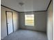 Cozy bedroom with neutral walls and carpet, featuring a window and closet at 30 Jamestown Ct Ct, Zebulon, NC 27597