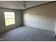 Spacious carpeted bedroom with neutral walls and a large window, creating a relaxing atmosphere at 30 Jamestown Ct Ct, Zebulon, NC 27597