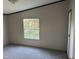 Bedoom with gray walls, carpeted floor, and a window overlooking the yard at 30 Jamestown Ct Ct, Zebulon, NC 27597