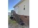 Image of the home's side entrance featuring stairs and a small wooden deck area at 30 Jamestown Ct Ct, Zebulon, NC 27597