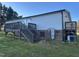 Back of home featuring a back entrance, steps, deck, and exterior utilities at 30 Jamestown Ct Ct, Zebulon, NC 27597