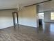 Open floorplan living room with ceiling fan and hardwood flooring flowing into the kitchen at 30 Jamestown Ct Ct, Zebulon, NC 27597