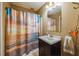 Functional bathroom with a shower featuring a vibrant ocean-themed curtain and classic vanity at 3012 Optimist Farm Rd, Apex, NC 27539