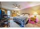 Spacious bedroom featuring a ceiling fan, comfortable bed, and ample natural light at 3012 Optimist Farm Rd, Apex, NC 27539
