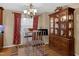 Dining room showcases a decorative chandelier and a wooden cabinet filled with dishware at 3012 Optimist Farm Rd, Apex, NC 27539