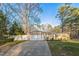 Detached two car garage with driveway and manicured lawn, offering convenience and curb appeal at 3012 Optimist Farm Rd, Apex, NC 27539