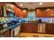 Well-lit kitchen with stainless steel appliances, granite countertops, and tile backsplash at 3012 Optimist Farm Rd, Apex, NC 27539