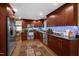 Bright kitchen featuring stainless steel appliances, dark cabinetry, and wood flooring at 3012 Optimist Farm Rd, Apex, NC 27539