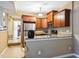 Well-equipped kitchen with granite countertops, stainless steel appliances, and warm wood cabinets at 3012 Optimist Farm Rd, Apex, NC 27539