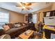 Cozy living room featuring a comfortable sofa, ceiling fan, and ample space for relaxation and entertainment at 3012 Optimist Farm Rd, Apex, NC 27539