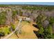 Beautiful aerial view showcasing a home nestled among lush trees with a private driveway at 3227 Morrow Farm Ln, Chapel Hill, NC 27516