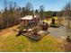 Beautiful aerial view of a home with outdoor entertaining space, fireplace, and lush landscape at 3227 Morrow Farm Ln, Chapel Hill, NC 27516