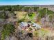 Aerial view of wooded acreage featuring home, outbuildings, and surrounding landscape at 3227 Morrow Farm Ln, Chapel Hill, NC 27516