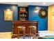 Finished basement bar featuring dark blue walls, artwork, and a dartboard at 3227 Morrow Farm Ln, Chapel Hill, NC 27516