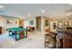 Finished basement area with a pool table, bar, and neutral carpeting at 3227 Morrow Farm Ln, Chapel Hill, NC 27516