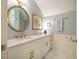 Stylish bathroom with a white vanity, marble countertops, and a round mirror at 3227 Morrow Farm Ln, Chapel Hill, NC 27516