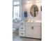 Well-lit bathroom with white vanity, oval mirror, and stylish fixtures at 3227 Morrow Farm Ln, Chapel Hill, NC 27516