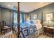 Relaxing bedroom with a beautiful quilt, natural light, and blue accent walls at 3227 Morrow Farm Ln, Chapel Hill, NC 27516