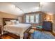 Bedroom with hardwood flooring, large bed, and dresser at 3227 Morrow Farm Ln, Chapel Hill, NC 27516