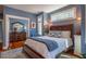 Bedroom featuring blue accent wall, hardwood floors, and a view into another room through the doorway at 3227 Morrow Farm Ln, Chapel Hill, NC 27516