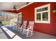 Relaxing covered porch with rocking chairs and ceiling fans, perfect for outdoor entertaining at 3227 Morrow Farm Ln, Chapel Hill, NC 27516