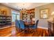 Hardwood floor dining room with chandelier, windows with natural views, and built-in bookcase at 3227 Morrow Farm Ln, Chapel Hill, NC 27516