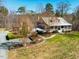 Expansive exterior view of this home with a wraparound porch, attractive landscaping, and a detached garage at 3227 Morrow Farm Ln, Chapel Hill, NC 27516