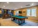 Spacious basement game room featuring a pool table and wet bar at 3227 Morrow Farm Ln, Chapel Hill, NC 27516