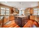 Open kitchen with a large island, stainless appliances, custom cabinetry, and hardwood floors at 3227 Morrow Farm Ln, Chapel Hill, NC 27516