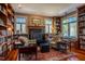A spacious living room with a fireplace, cozy seating, and extensive built-in bookshelves at 3227 Morrow Farm Ln, Chapel Hill, NC 27516