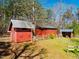 Outbuildings in the backyard with fenced area and tree covered surrounding at 3227 Morrow Farm Ln, Chapel Hill, NC 27516