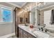 Bathroom featuring double sinks, a granite countertop, and a large mirror at 3240 Donlin Dr, Wake Forest, NC 27587