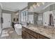 Bathroom with dual vanities, freestanding tub, tile accents, and designer fixtures at 3240 Donlin Dr, Wake Forest, NC 27587