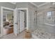 This bathroom showcases a glass shower, tile floors, and a glimpse into the bedroom at 3240 Donlin Dr, Wake Forest, NC 27587