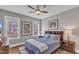 This bedroom offers two windows, hardwood floors, a ceiling fan, and natural light at 3240 Donlin Dr, Wake Forest, NC 27587