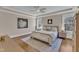 Primary bedroom with tray ceiling, hardwood floors, two windows, and neutral decor at 3240 Donlin Dr, Wake Forest, NC 27587
